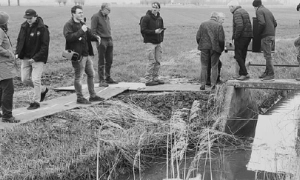 People standing around a weir