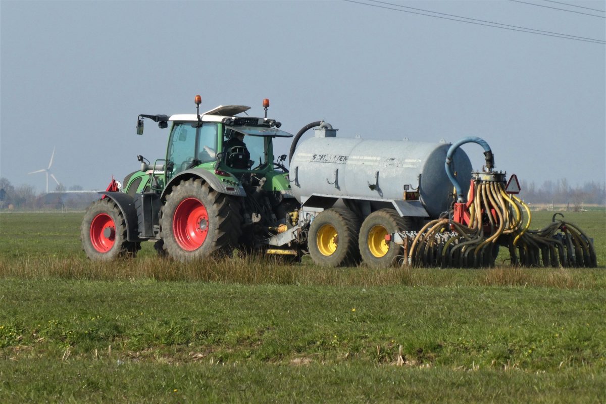Tractor applying liquid manure to grassland