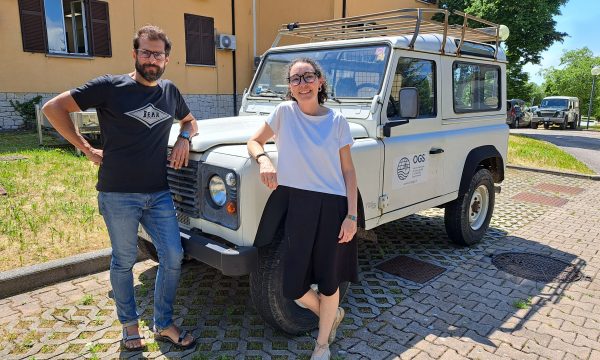 Matteo Vinci and Maria Eugenia Molina Jack standing in front of a jeep