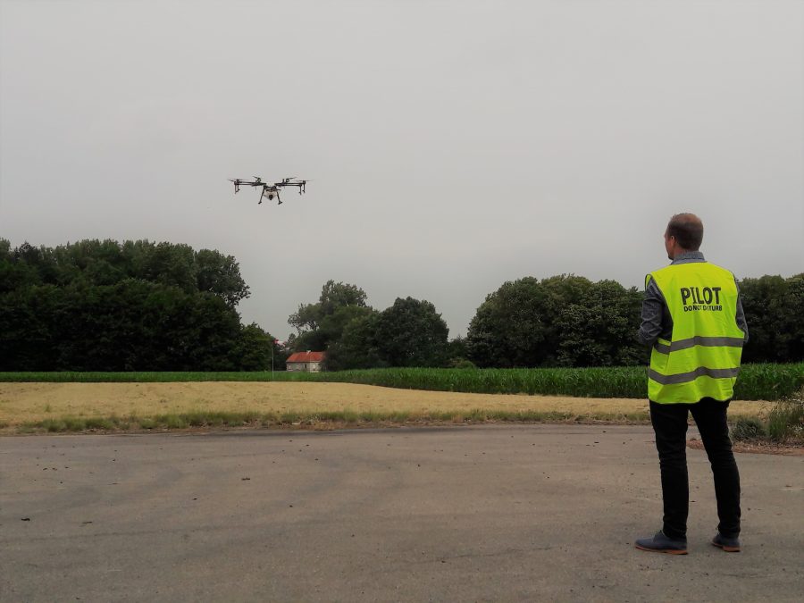 Dronepilot vliegt met drone boven akker