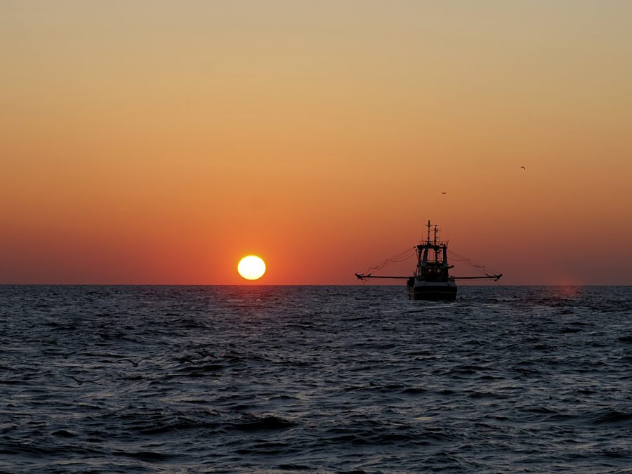 Vissersboot bij zonsondergang